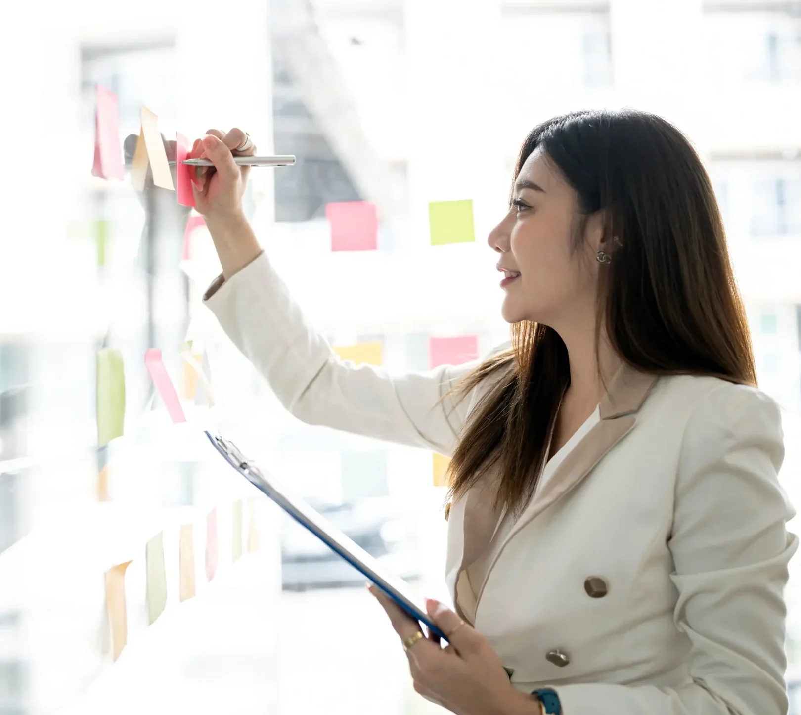 Investment professional mapping equity strategy on sticky notes during portfolio planning workshop.