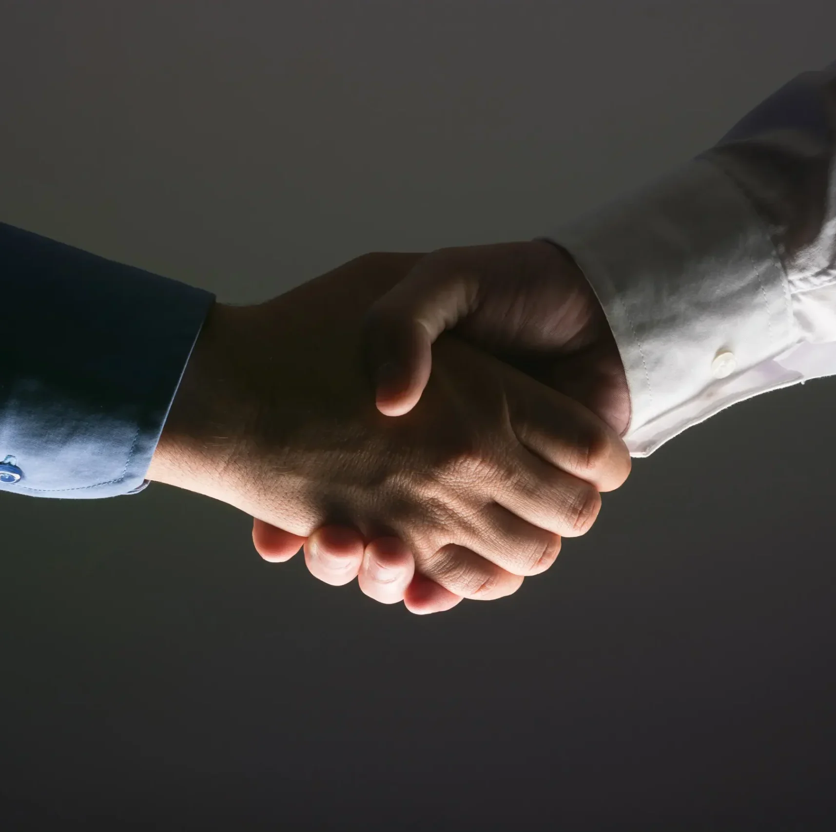 Close-up handshake symbolising trusted long-term investment partnership.